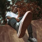 Close-up of black sneakers in an outdoor urban environment, cool and casual vibe.