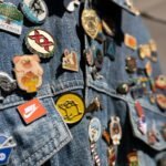 Close-up of vibrant pins on a denim jacket at a market in Guadalajara.